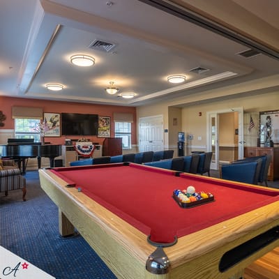 An interior common area with a pool table and seating