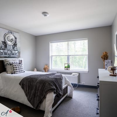 A cozy resident room with a bed and decor