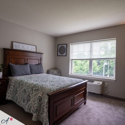 Cozy interior of a resident bedroom with a large window