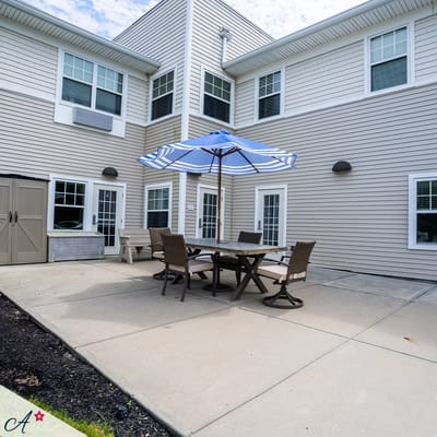 Outdoor seating area with umbrella and tables