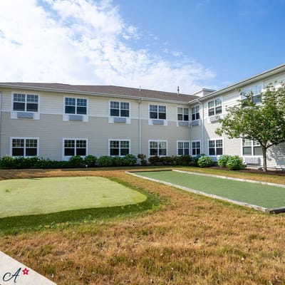 Exterior view of the assisted living facility with a garden