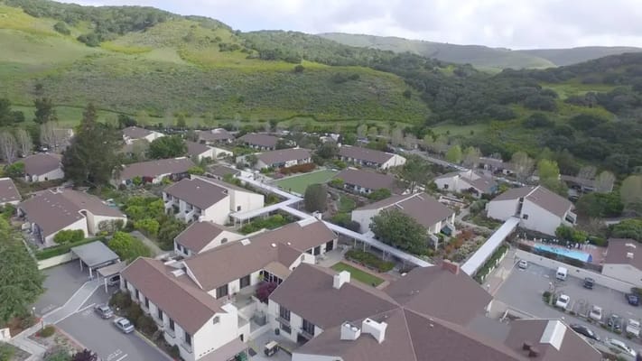 Aerial view of a senior living campus surrounded by greenery