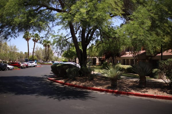 Outdoor view of the facility with trees and parking
