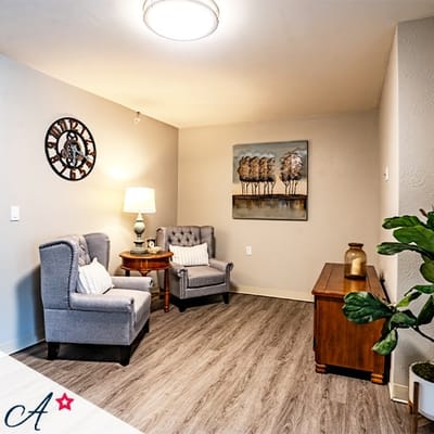 Cozy sitting area with two chairs and decorative artwork
