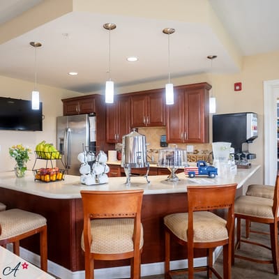Bright common area with a kitchen bar and seating