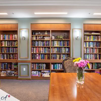 Cozy library area with bookshelves and flowers