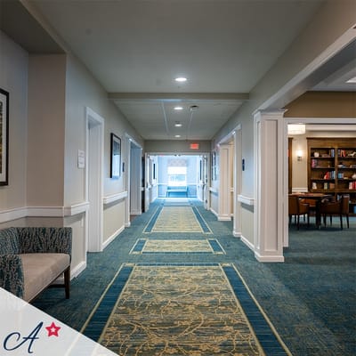 Bright interior hallway with seating and bookshelf
