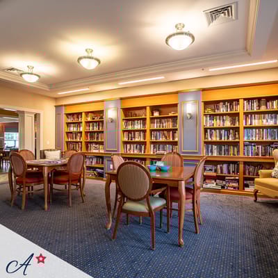 Interior view of a cozy library with bookshelves and tables
