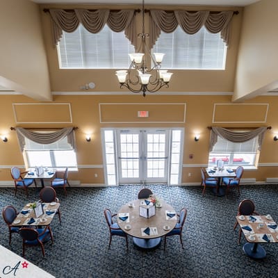 Interior view of a dining room with tables and chairs