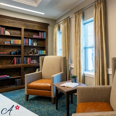 Cozy reading area with armchairs and bookshelves