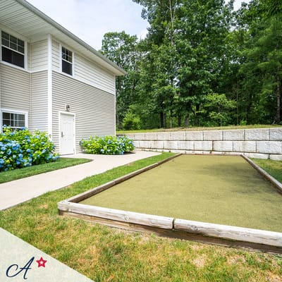 Outdoor bocce ball court with greenery