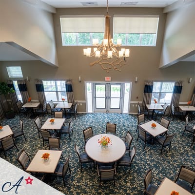 Bright dining area with tables and flowers