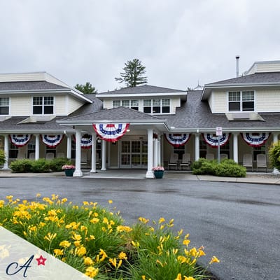 Exterior view of an assisted living facility with flowers and decorations