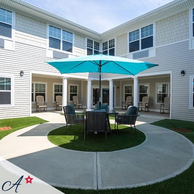 Outdoor seating area with a bright umbrella and chairs