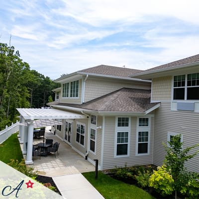 Exterior view of the assisted living facility with outdoor seating