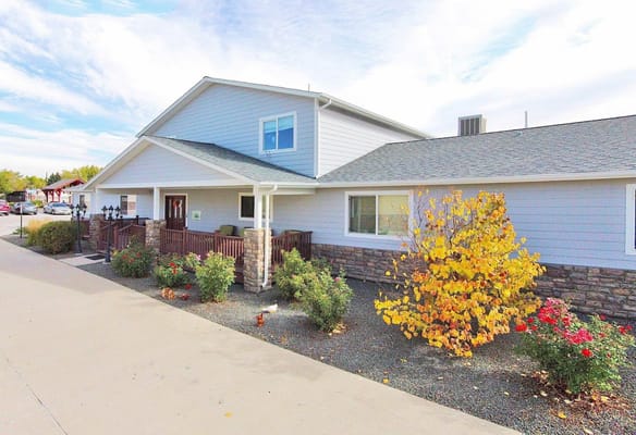 Exterior view of a senior living facility with colorful foliage