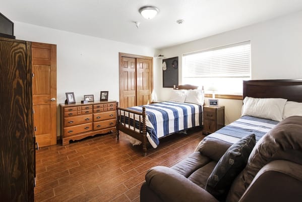 Cozy interior of a resident room with two beds and furniture