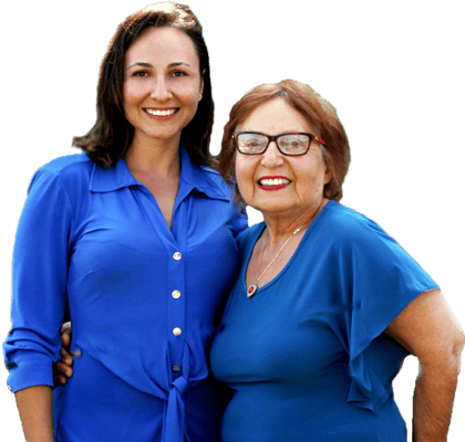 Two women smiling in a garden setting