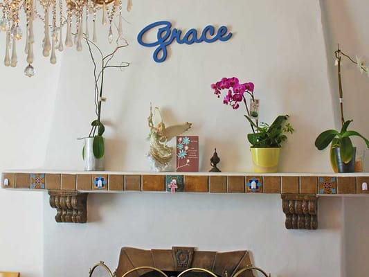 Interior decor featuring plants and a sign that says 'Grace'
