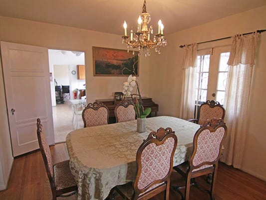 Elegant dining room with chandelier and large table.