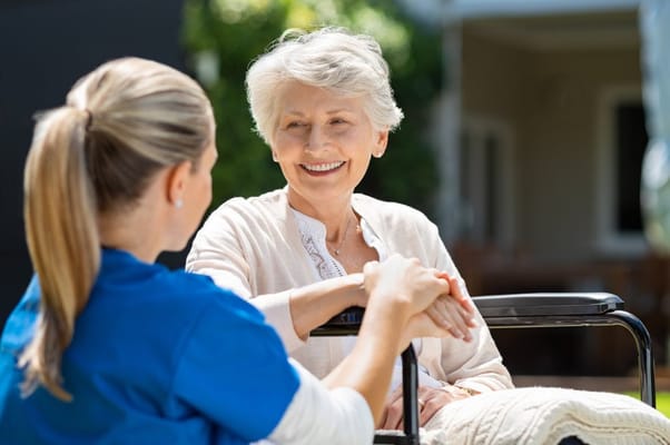 A caregiver interacting with a resident outside