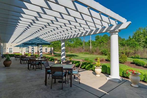 Outdoor patio area with seating and greenery