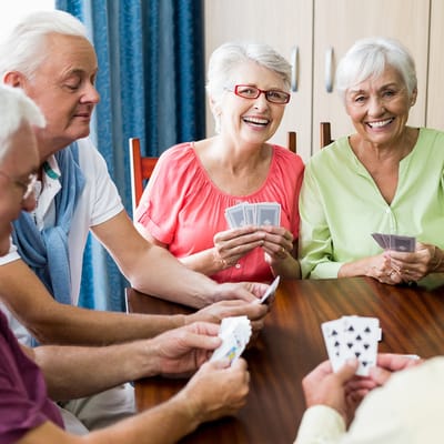 Residents enjoying a card game in a common area