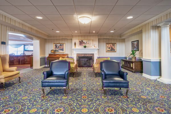 Comfortable common area with chairs and a fireplace