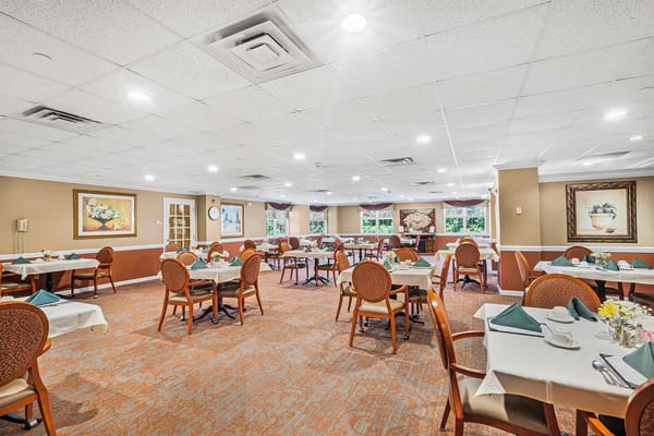 Bright dining area with tables set for residents