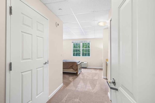 Interior view of a resident room with a bed and window