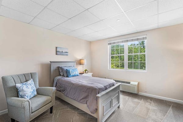 Cozy bedroom setup with a view and comfortable furnishings