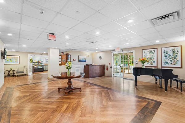 Interior view of a welcoming common area with a piano