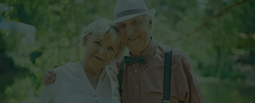 Couple smiling outdoors in a natural setting