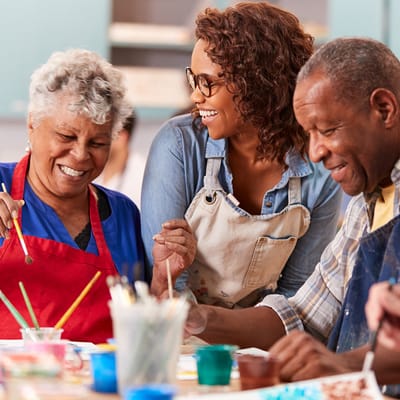 Residents and staff enjoying a painting activity