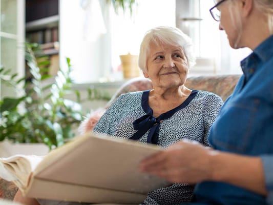 A senior resident engaging in conversation with staff