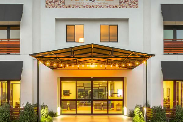 Entrance of a senior living facility with outdoor lighting