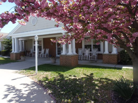 Exterior view of facility with flowering trees