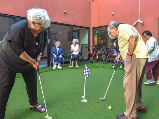 Residents enjoying a game of golf in an outdoor space