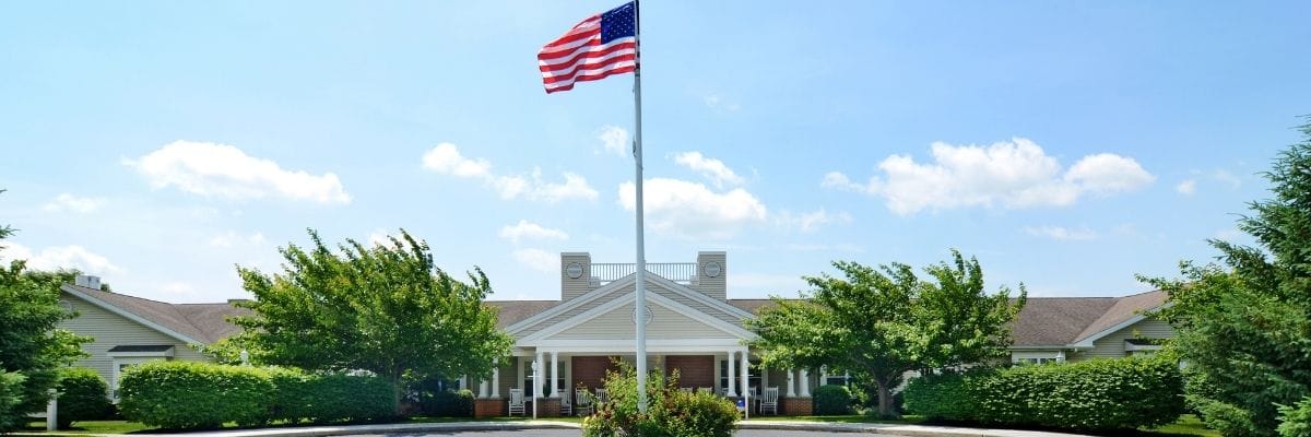 Exterior view of assisted living facility with American flag