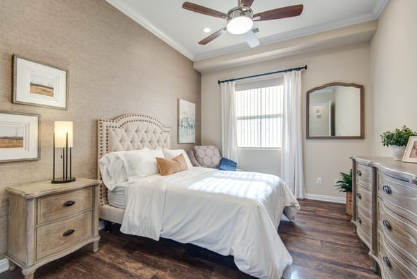 Brightly decorated resident room with a bed and furniture