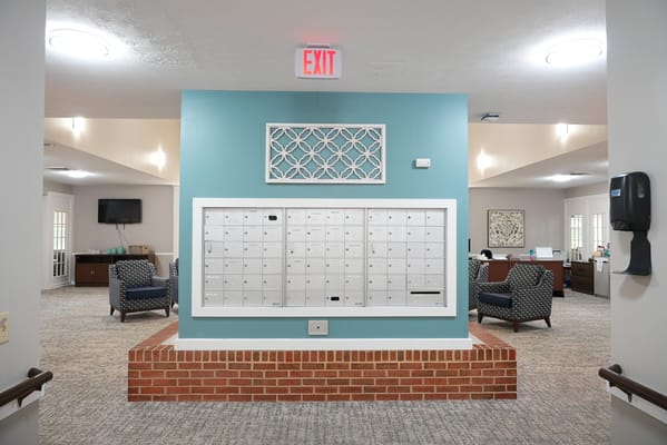 Interior view of a common area with seating and mailboxes