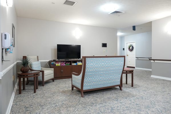 Bright common area with seating and TV