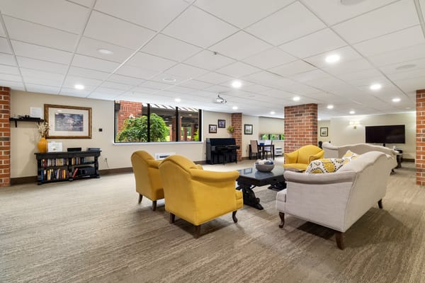 Common area with seating and piano in a cozy lounge