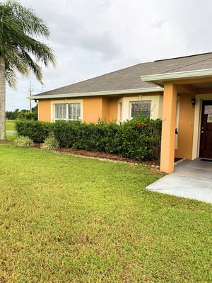 Exterior view of a senior living facility with landscaping