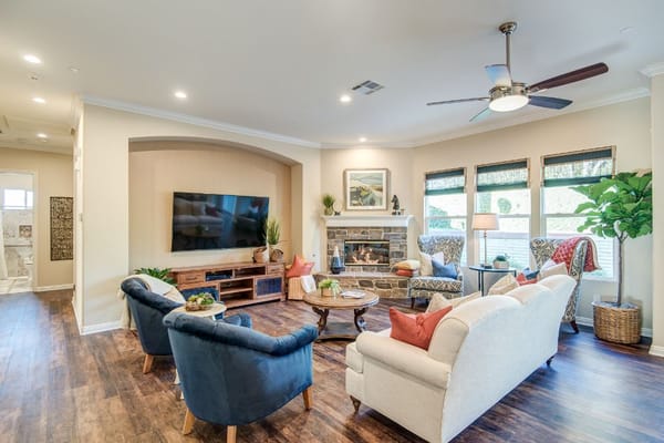 Bright common area with comfortable seating and a fireplace