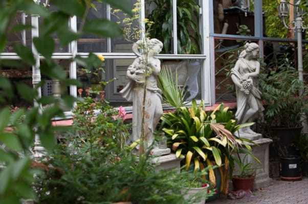 Outdoor garden with sculptures and greenery