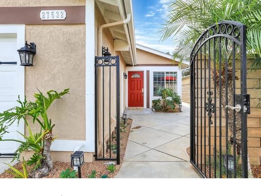 Welcoming entrance with a red door and landscaped path