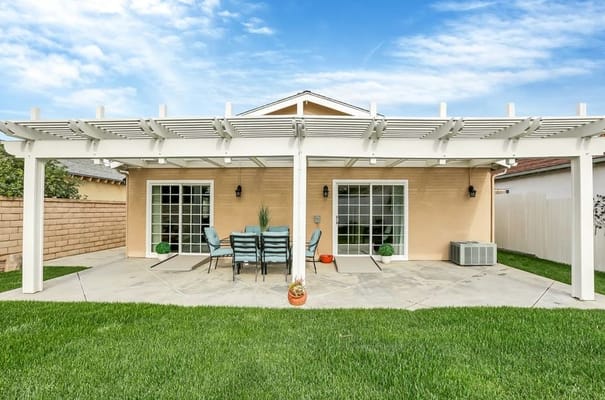 Outdoor patio area with seating and greenery