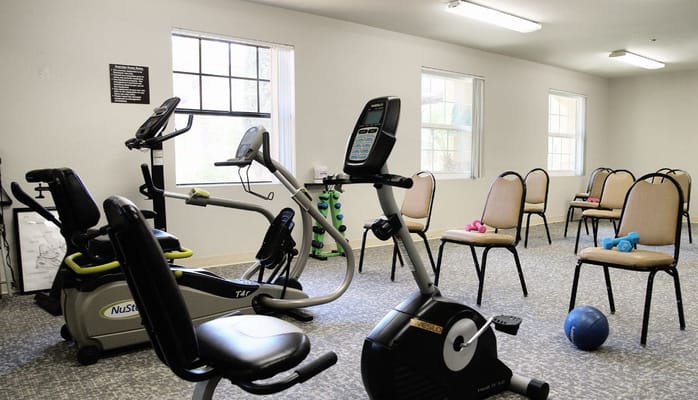 Fitness room with exercise equipment and chairs, Atria Campana del Rio.