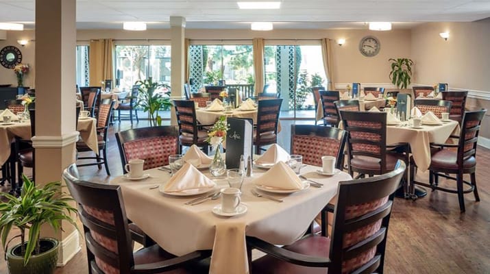 Elegant dining area with tables set for a meal.